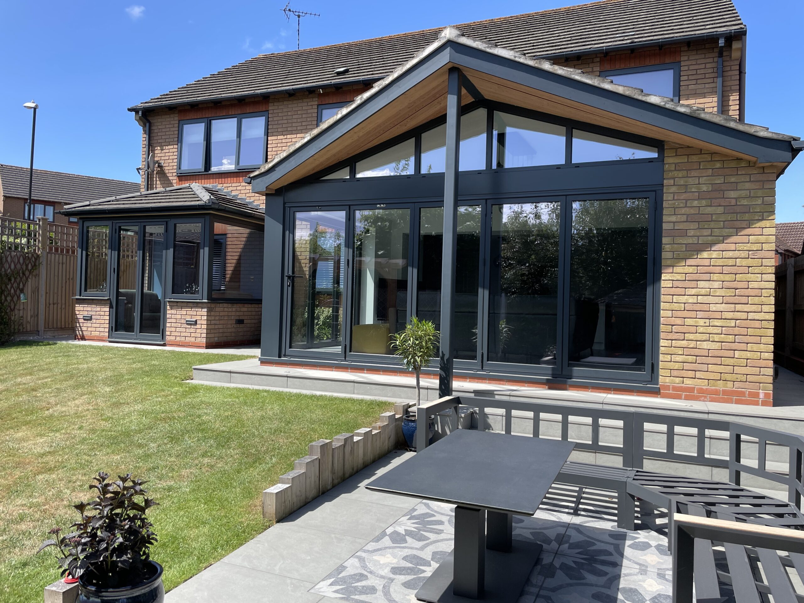 Modern rear kitchen extension with bifold doors and porcelain slabs patio area built in Coventry